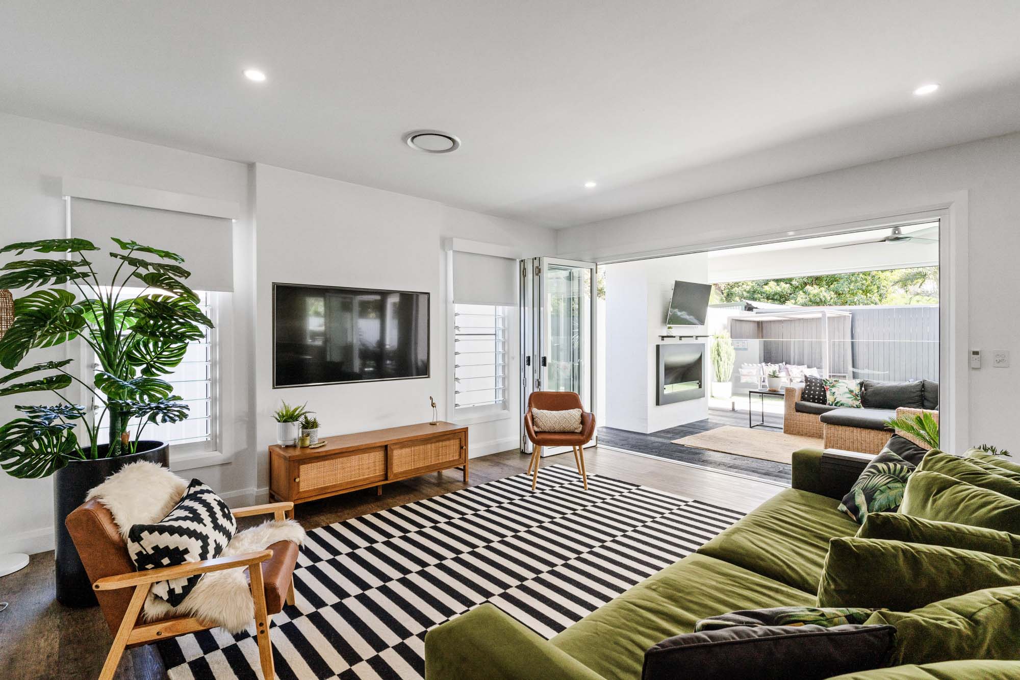 Media room with fireplace in newly renovated property in East Ballina, Northern Rivers NSW completed by MGM Construction.
